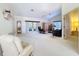 Spacious living room features bright white carpet, vaulted ceilings, and a ceiling fan at 8447 Pavilion Dr, Hudson, FL 34667