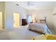 Bright main bedroom with ceiling fan, neutral carpet, and large windows at 8447 Pavilion Dr, Hudson, FL 34667