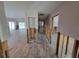 Hallway featuring wood-look tile flooring and open doorways leading to various rooms in the home at 103 Carlyle Dr, Palm Harbor, FL 34683