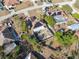 Birds eye view showing home with solar panels, fenced yard, lush trees, and an in-ground pool in a quiet neighborhood at 11081 Montcalm Rd, Spring Hill, FL 34608