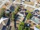 Overhead image of home with solar panels, mature trees, fenced yard, and a unique in-ground pool in residential area at 11081 Montcalm Rd, Spring Hill, FL 34608