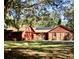 Inviting single-story home featuring solar panels, a two-car garage, and an expansive front yard at 1224 Candlelight Blvd, Brooksville, FL 34601