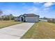 Charming single-story home features a well-manicured lawn and attached two-car garage at 12490 Meinert Ave, Brooksville, FL 34613