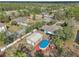 Aerial view of a house with an above ground pool and detached metal garage at 13083 Jaywalk Rd, Brooksville, FL 34614