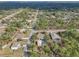 An aerial view capturing the home and property in a wooded neighborhood at 13083 Jaywalk Rd, Brooksville, FL 34614