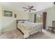 Bright bedroom features a ceiling fan, a comfortable bed and a sun-filled window at 13083 Jaywalk Rd, Brooksville, FL 34614