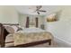 This bright bedroom features a ceiling fan, a comfortable bed and a large flat screen TV at 13083 Jaywalk Rd, Brooksville, FL 34614