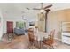 Cozy dining area with a wood table and chairs, wood-burning stove, and a view of the living room at 13083 Jaywalk Rd, Brooksville, FL 34614
