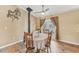Bright dining area with a wood-burning stove, French doors, and wood-look tile flooring at 13083 Jaywalk Rd, Brooksville, FL 34614