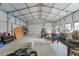 Interior of a spacious detached garage with a roll-up door at 13083 Jaywalk Rd, Brooksville, FL 34614