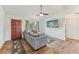 Living room features gray couch, ceiling fan, exterior door, and tile flooring at 13083 Jaywalk Rd, Brooksville, FL 34614