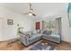 Living room features gray sectional sofa, ceiling fan, and tile flooring at 13083 Jaywalk Rd, Brooksville, FL 34614