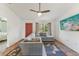 View of the living room showcasing a gray sectional sofa, ceiling fan, and tile flooring at 13083 Jaywalk Rd, Brooksville, FL 34614