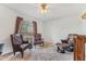 Sitting room with three leather chairs, carpeted floor, and natural light from the large window at 13083 Jaywalk Rd, Brooksville, FL 34614