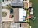 Aerial view of home with well-maintained roof, driveway, backyard, and canal access at 13603 Jennita Dr, Hudson, FL 34667