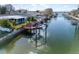 A waterfront view of a cozy home, featuring a private boat dock and access to serene canal waters at 13603 Jennita Dr, Hudson, FL 34667