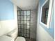 Bathroom featuring a modern walk-in shower with black trim and blue and white walls at 13603 Jennita Dr, Hudson, FL 34667