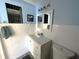 Bathroom featuring a white vanity, subway tile walls, modern fixtures and a matching toilet at 13603 Jennita Dr, Hudson, FL 34667