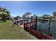 Waterfront dock with bench seating offers serene views, providing an ideal spot for relaxation by the canal at 13603 Jennita Dr, Hudson, FL 34667