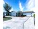 Charming one-story home boasting a well-manicured lawn, mature trees, and a welcoming driveway at 13603 Jennita Dr, Hudson, FL 34667