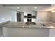 Modern kitchen featuring a large island, granite countertops, and sleek stainless steel appliances at 13603 Jennita Dr, Hudson, FL 34667