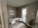 Home office with a modern white desk, decorative art, tile floors, and a glass door to the outdoors at 13603 Jennita Dr, Hudson, FL 34667