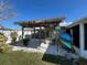 Charming outdoor area with tiki-style cover, white gravel, potted plants, and convenient kayak storage at 13603 Jennita Dr, Hudson, FL 34667