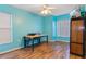 Bright bedroom featuring wood floors, a ceiling fan, and a desk perfect for work or study at 1474 Godfrey Ave, Spring Hill, FL 34609