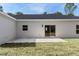 Backyard view with a well-maintained lawn and patio, offering outdoor living and entertainment at 18020 Macek Rd, Weeki Wachee, FL 34614