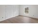 Bedroom with light wood floors and large window at 18020 Macek Rd, Weeki Wachee, FL 34614