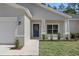 Close up of charming home exterior featuring a well-manicured lawn and inviting front entrance at 18020 Macek Rd, Weeki Wachee, FL 34614