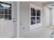 Exterior view of front door and large window showcasing natural light at 18020 Macek Rd, Weeki Wachee, FL 34614