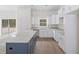 Open-concept kitchen with white cabinets, granite countertops, an island with a breakfast bar, and stainless appliances at 18020 Macek Rd, Weeki Wachee, FL 34614