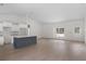 Bright, open-concept living area with a large window, white cabinets, and a contrasting kitchen island at 18020 Macek Rd, Weeki Wachee, FL 34614