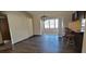 Open dining room with dark floors, chandelier, and bar seating area at 2013 Meredith Dr, Spring Hill, FL 34608