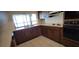A view of the kitchen with white tiled floors and older appliances at 2013 Meredith Dr, Spring Hill, FL 34608