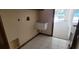 Practical laundry room featuring tile floor, utility sink, and laundry hookups at 2013 Meredith Dr, Spring Hill, FL 34608