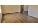 Spacious living room featuring wood laminate flooring, neutral walls, and a cozy atmosphere at 2013 Meredith Dr, Spring Hill, FL 34608