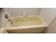 Relaxing yellow soaking tub with jets in a cozy bathroom setting at 2013 Meredith Dr, Spring Hill, FL 34608