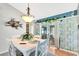 Dining room with white table and chairs, decorative accents, and sliding door access to lanai at 2089 Cottondale Ave, Spring Hill, FL 34608