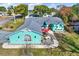 Spacious home with a well-manicured yard, red front doors and a charming patio area at 2334 Gimlet, Spring Hill, FL 34608