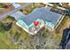 An aerial view of a blue home with a red umbrella on the patio, a gray roof, and a walkway surrounding it at 2334 Gimlet, Spring Hill, FL 34608