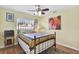 Cozy bedroom with bright yellow walls, wood floors and a metal-frame bed near a bright window at 2334 Gimlet, Spring Hill, FL 34608