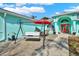 Inviting turquoise home featuring an outdoor patio with seating, perfect for enjoying the weather at 2334 Gimlet, Spring Hill, FL 34608