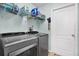 Practical laundry area featuring modern washer and dryer with shelving for storage at 2334 Gimlet, Spring Hill, FL 34608
