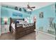 Bright main bedroom with coastal decor, a large window, and a ceiling fan at 2334 Gimlet, Spring Hill, FL 34608
