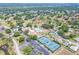 A community with a pool, clubhouse, tennis courts, a golf course, and residences are seen from above at 2862 Lomond Dr, Palm Harbor, FL 34684