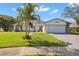 Bright bathroom featuring a granite countertop vanity with white cabinets and a glass-enclosed shower at 2862 Lomond Dr, Palm Harbor, FL 34684