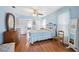 Comfortable bedroom boasts natural light, ceiling fan, and wood floors at 2862 Lomond Dr, Palm Harbor, FL 34684