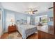 Bright bedroom with hardwood floors, ceiling fan and access to a sunroom at 2862 Lomond Dr, Palm Harbor, FL 34684
